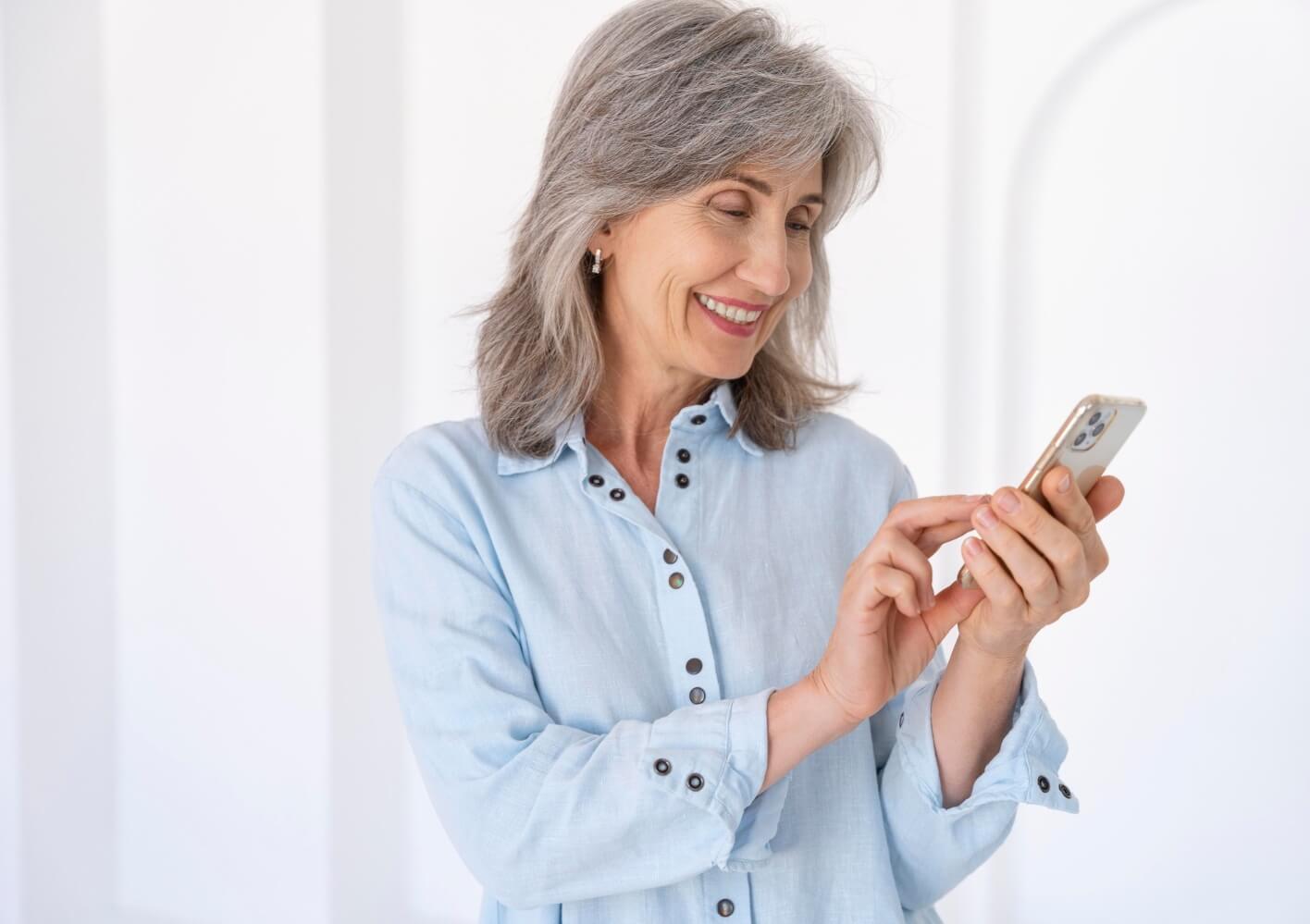 Confident mature woman using her phone